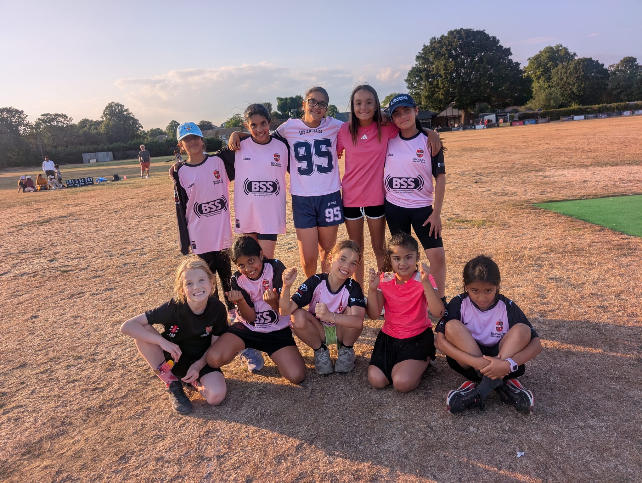 Bromley U11 Peregrines posing together on the cricket ground.