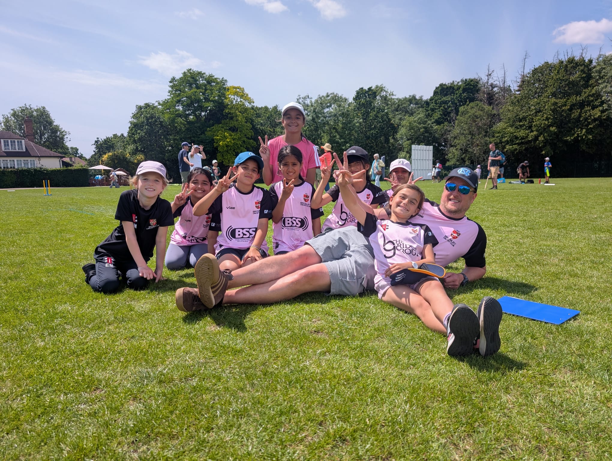 Bromley U9 Eagles and their coach enjoying a sunny day at the cricket ground.